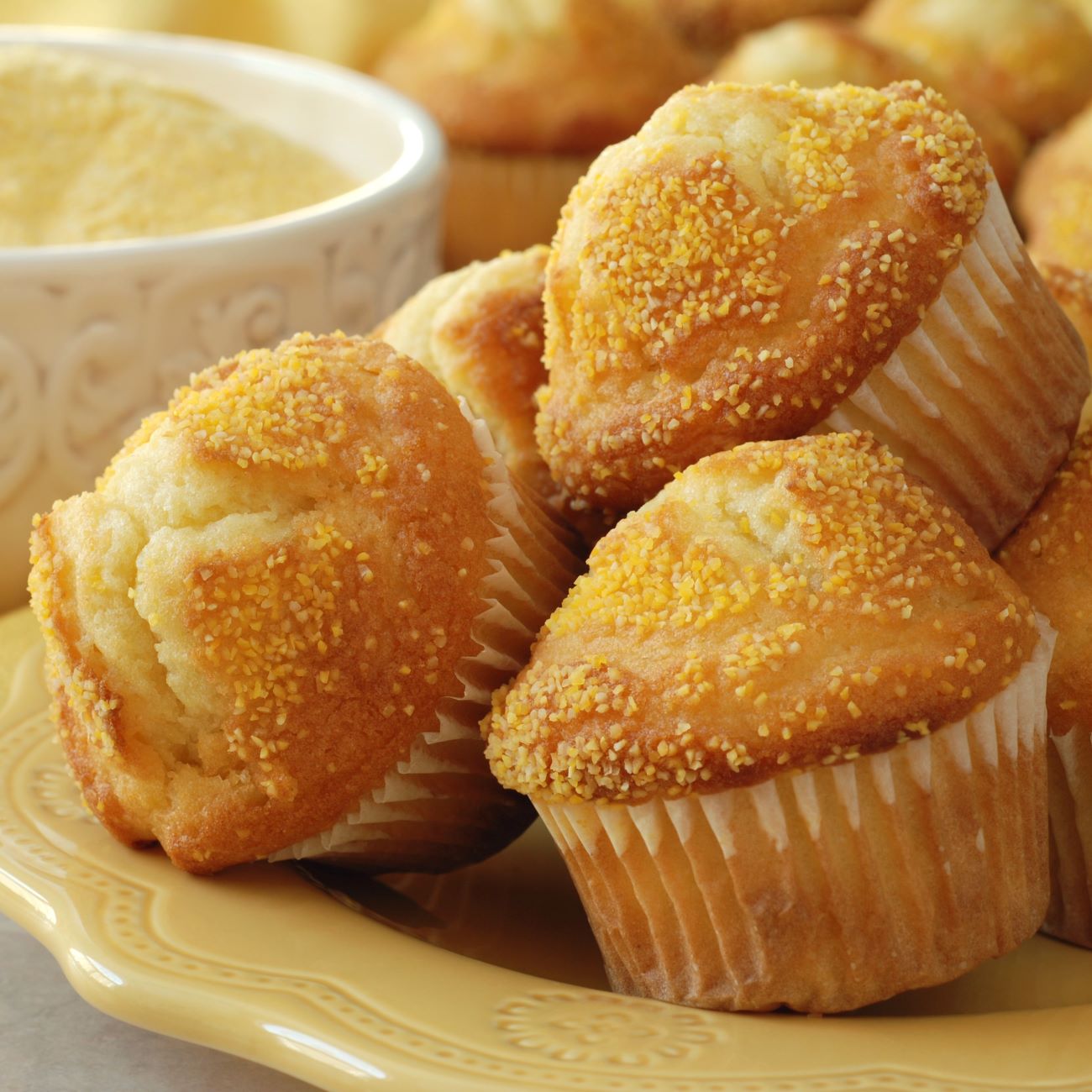 Babeczki z chleba kukurydzianego pokazane są ułożone w stos na żółtym talerzu.